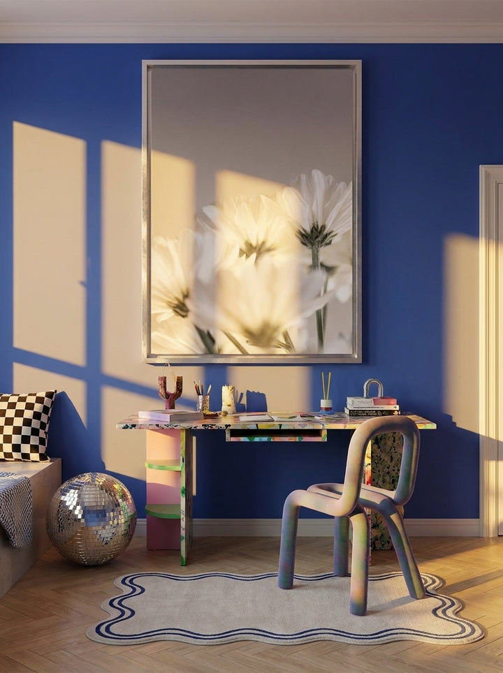 Canvas wall art with a silver leaf surround styled on the wall in a colourful eclectic home office
