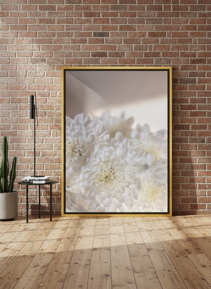 Canvas wall art with a gold leaf surround leaning against the wall in an industrial loft bedroom