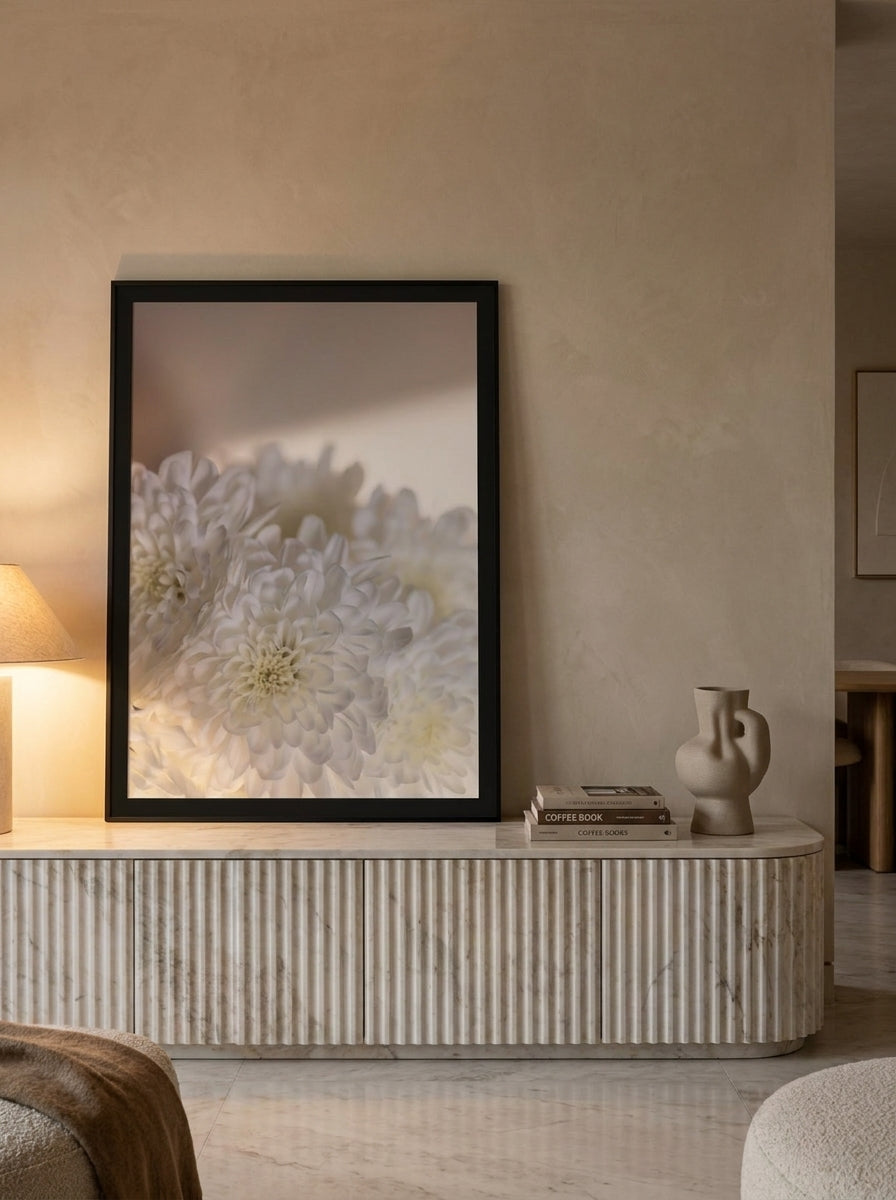 Modern wall art print standing on a sideboard in a luxe living room
