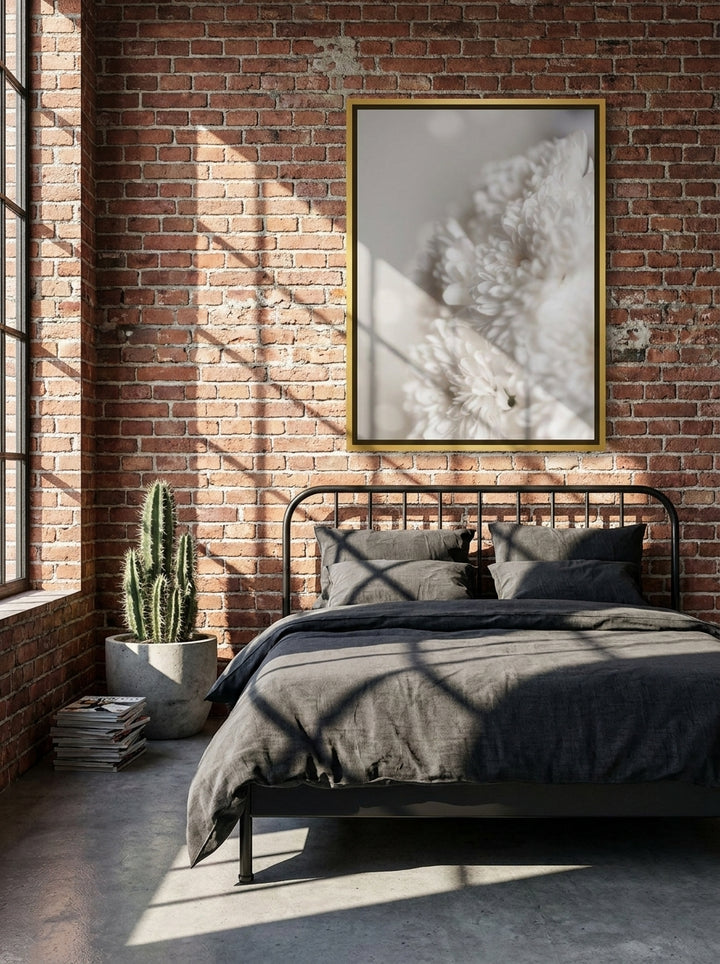 Canvas wall art with a gold leaf surround styled on the wall in an industrial loft bedroom