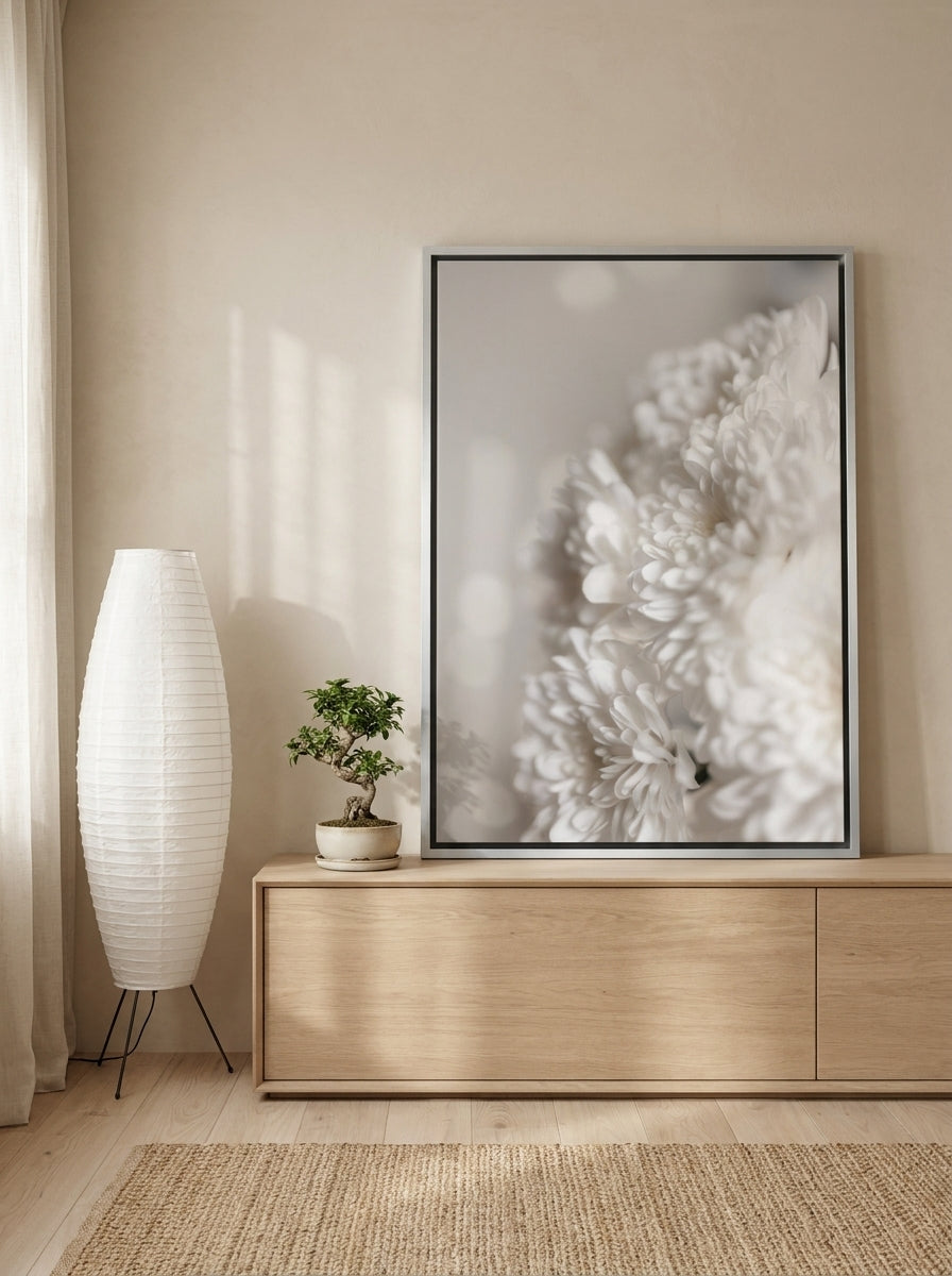 Canvas wall art with a silver leaf surround standing on a sideboard in a warm Japandi bathroom