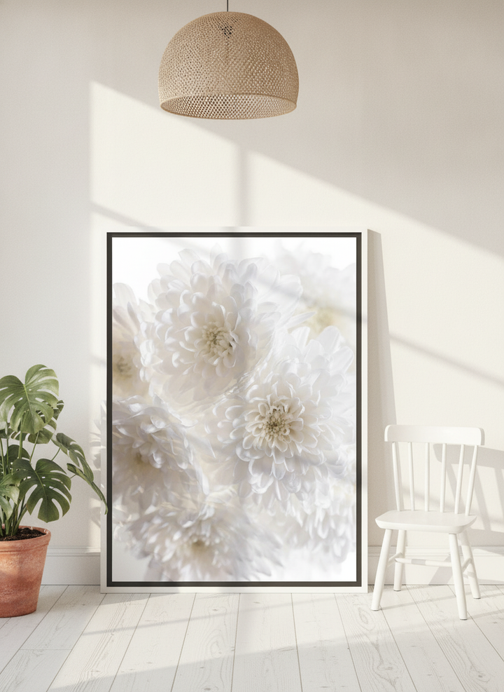 Canvas wall art with a white surround leaning against the wall in a bright Scandinavian nursery