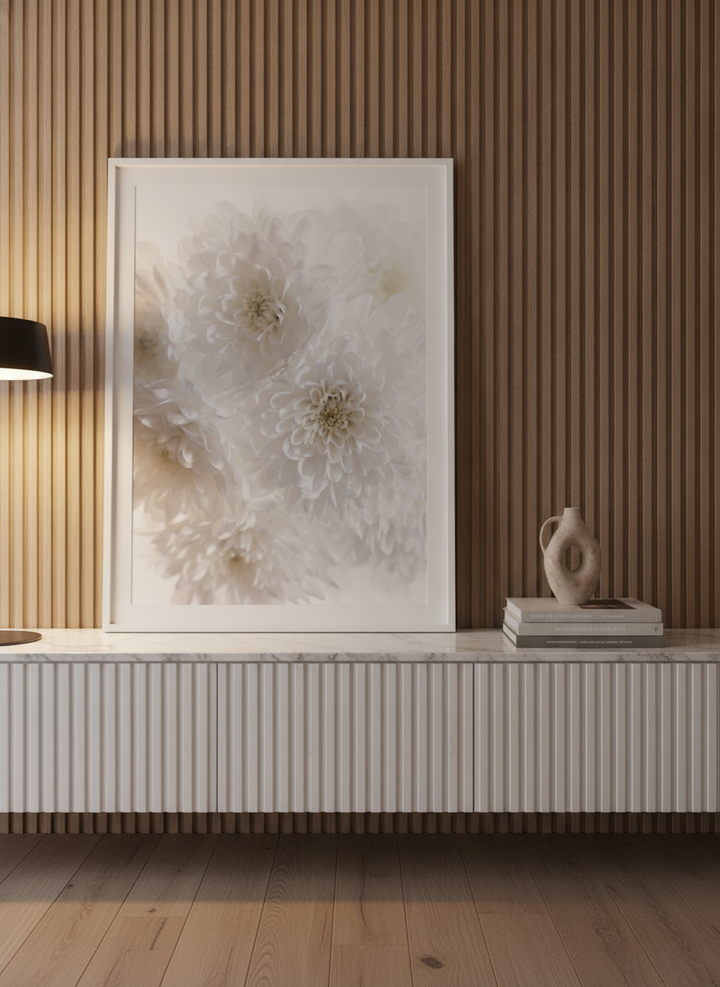 Modern wall art print standing on a sideboard in a luxe bedroom