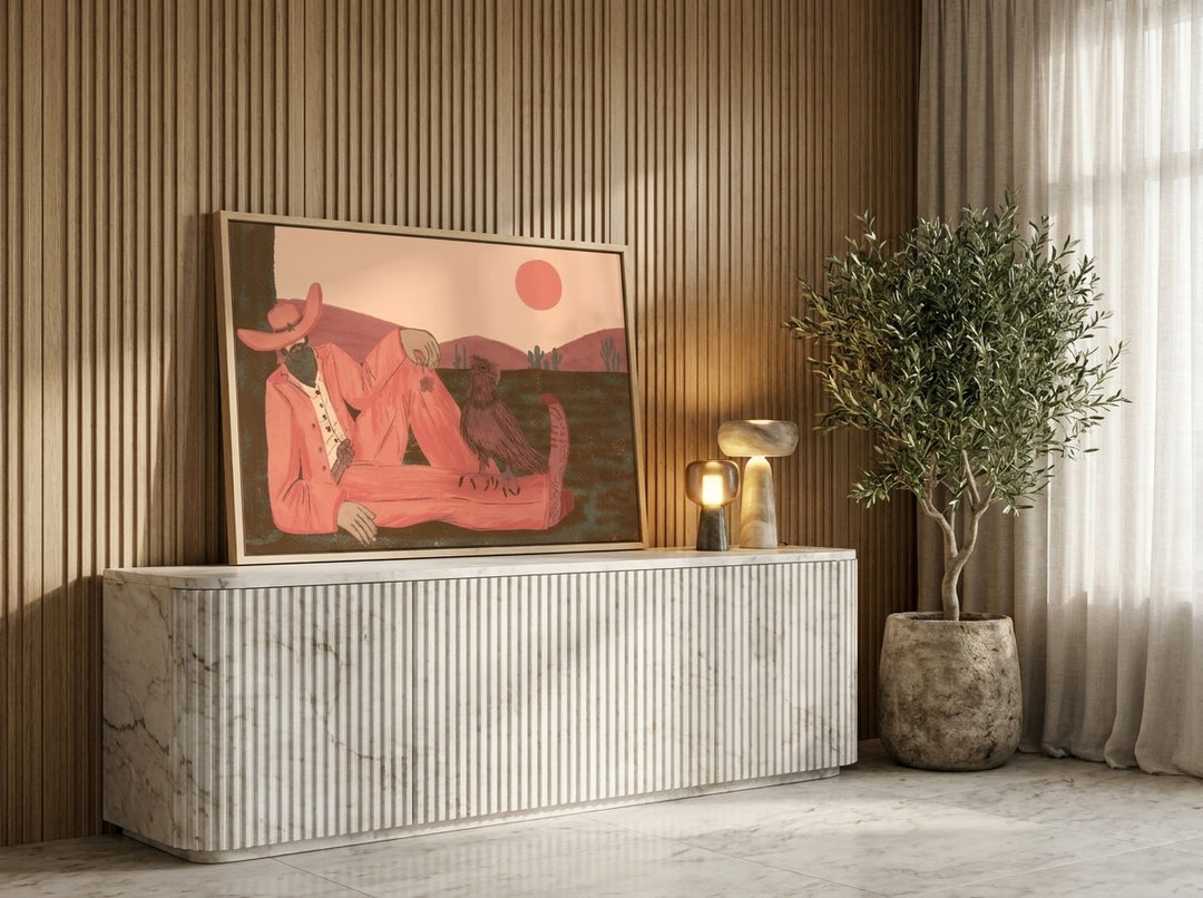Canvas wall art with a natural timber surround standing on a sideboard in a luxe home office