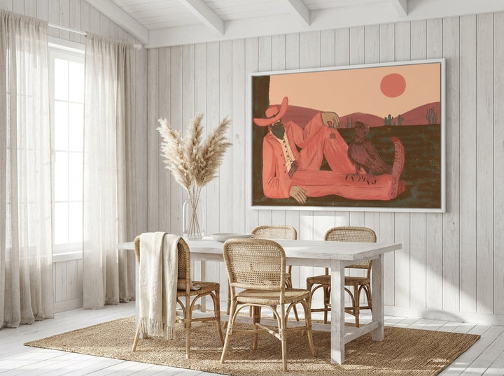 Oversized statement canvas wall art with a white surround styled on the wall in a coastal dining room