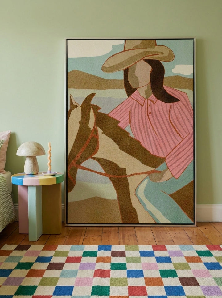 Oversized statement canvas wall art with a silver leaf surround leaning against the wall in a colourful eclectic bedroom