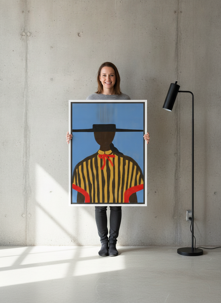Person holding canvas wall art with a white surround in an industrial loft living room
