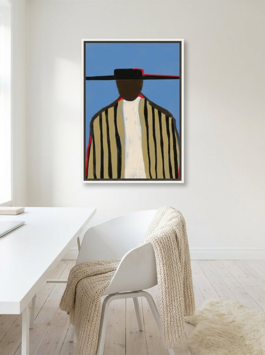 Canvas wall art with a white surround styled on the wall in a bright Scandinavian home office