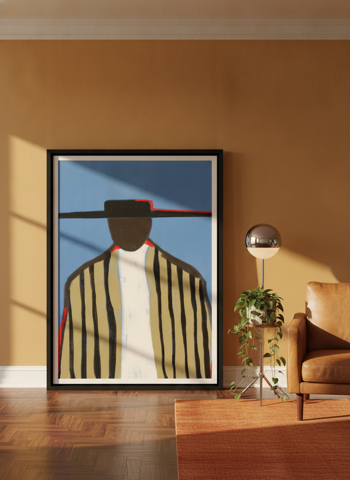 Oversized statement canvas wall art with a black surround leaning against the wall in a retro 70s living room