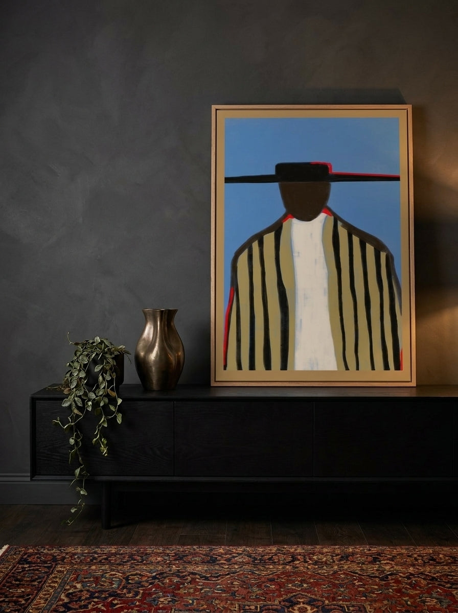 Modern wall art print standing on a console in a moody bedroom