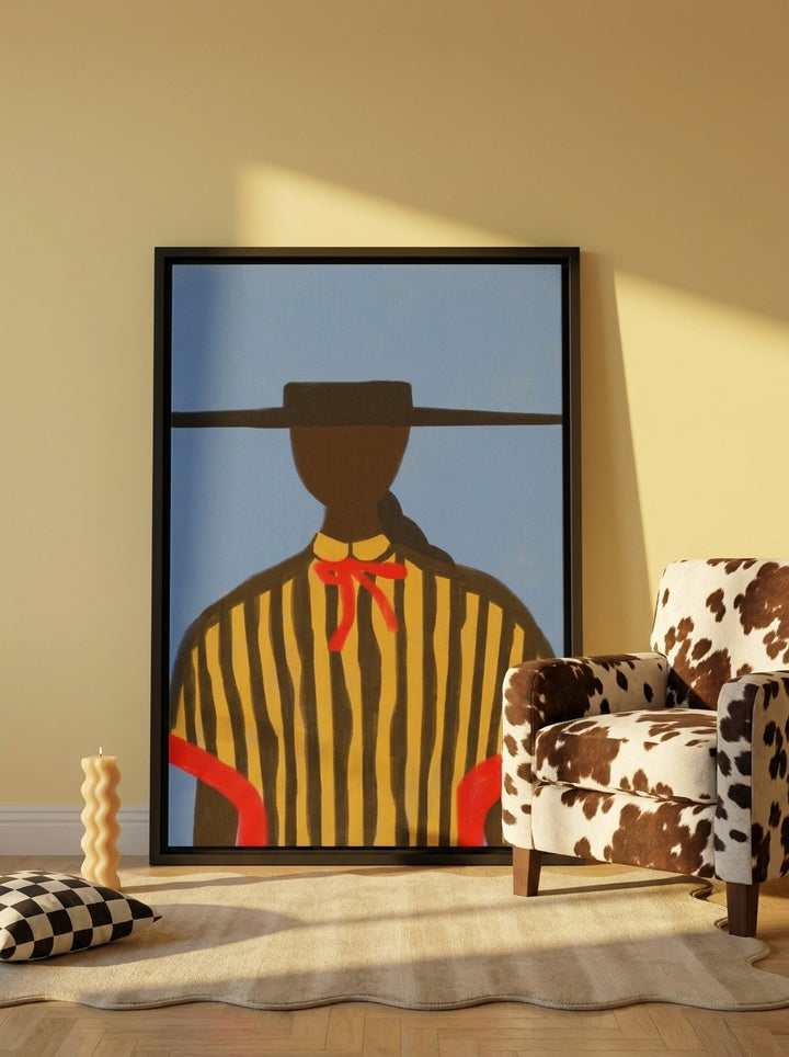 Oversized statement canvas wall art with a black surround leaning against the wall in a colourful eclectic dining room