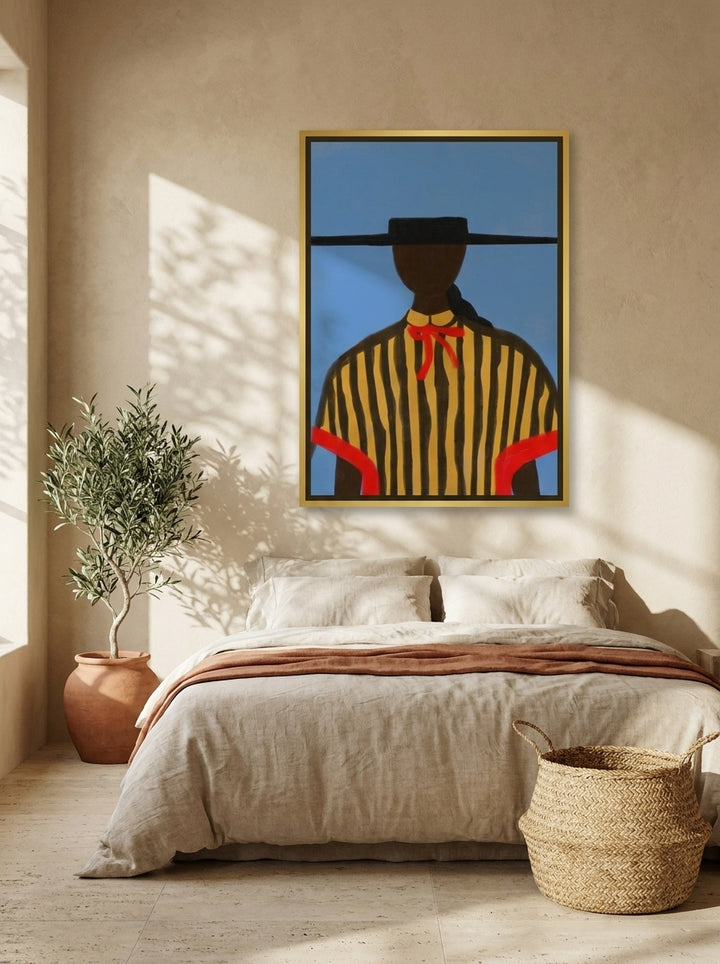 Canvas wall art with a gold leaf surround styled on the wall in a Mediterranean bedroom