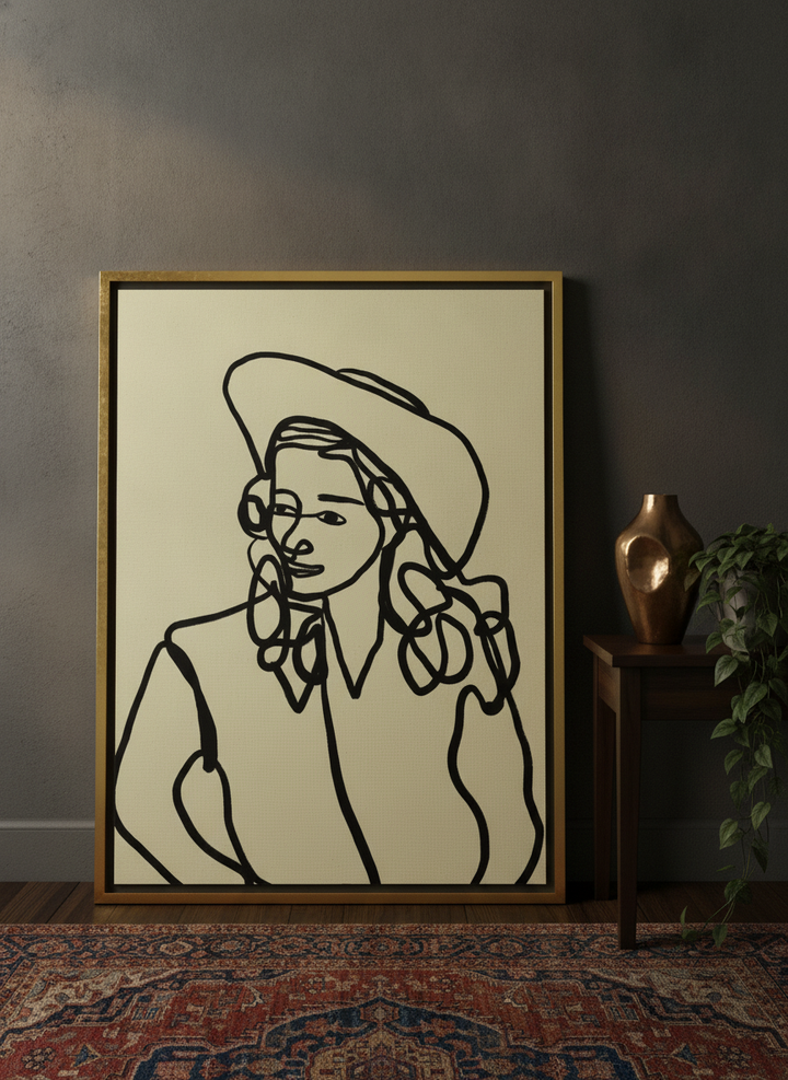 Canvas wall art with a gold leaf surround leaning against the wall in a moody home office