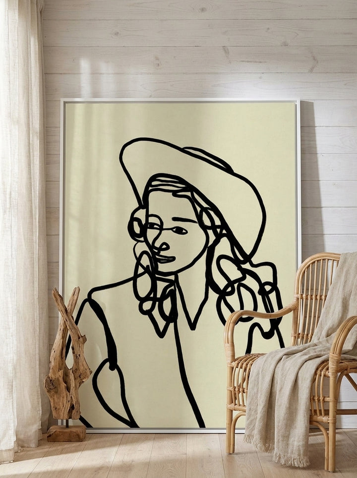 Oversized statement canvas wall art with a white surround leaning against the wall in a coastal living room