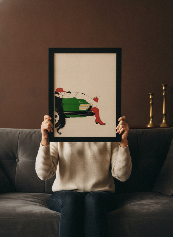 Person holding modern wall art print in a moody living room