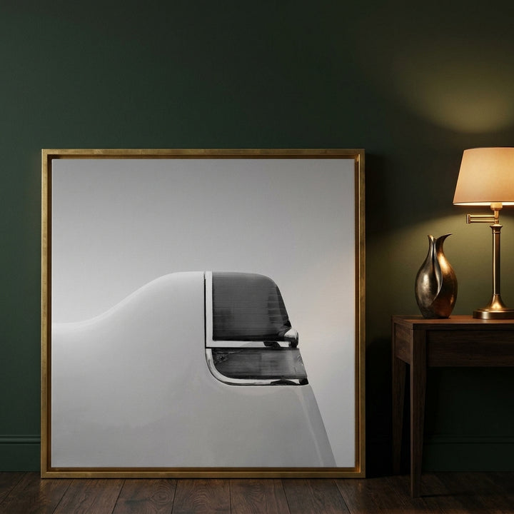 Canvas wall art with a gold leaf surround leaning against the wall in a moody home office