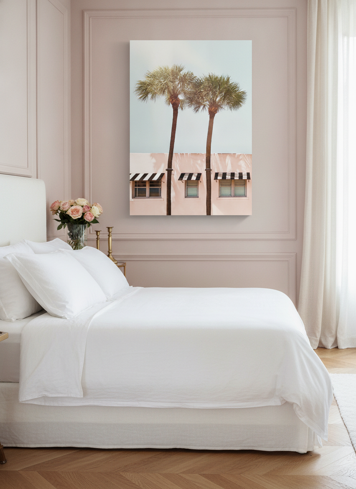 Stretched canvas wall art styled on the wall in a Parisian bedroom