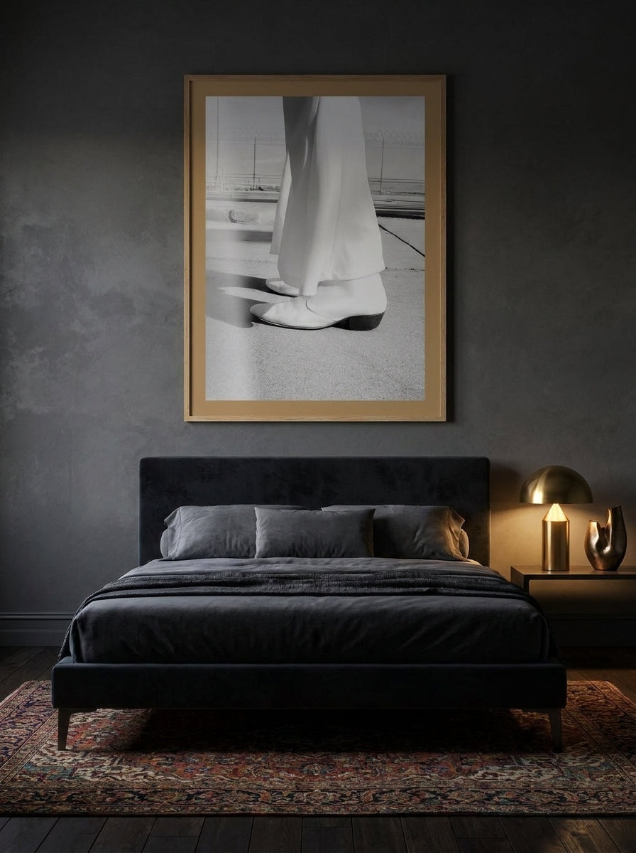 Modern wall art print styled on the wall in a moody bedroom
