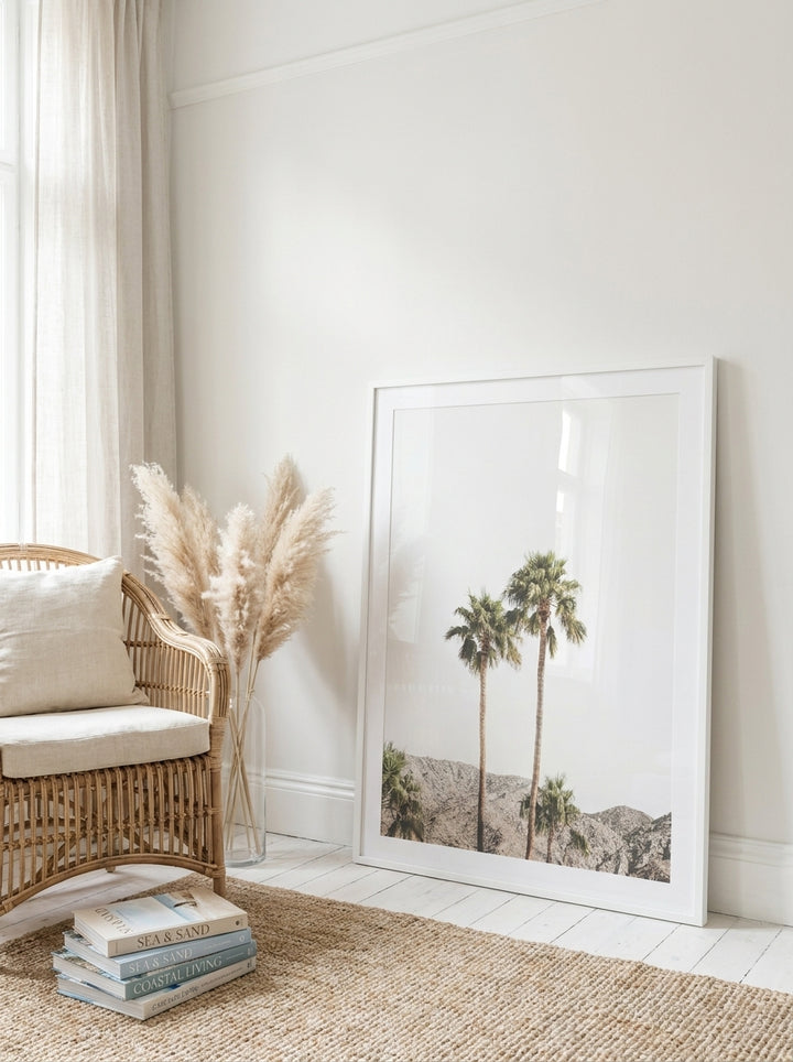 Oversized statement modern wall art print leaning against the wall in a coastal bedroom
