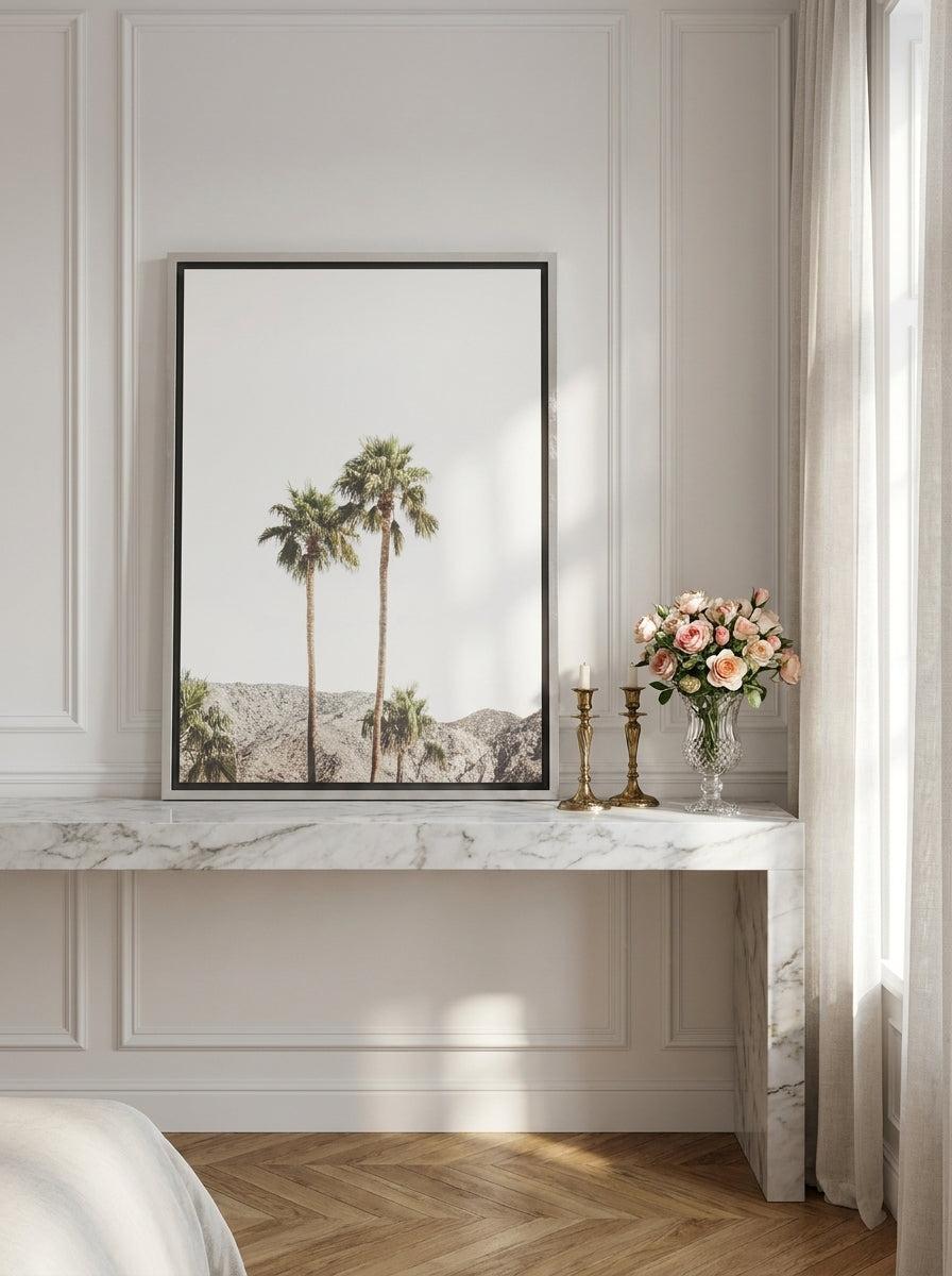 Canvas wall art with a silver leaf surround standing on a console in a Parisian bedroom