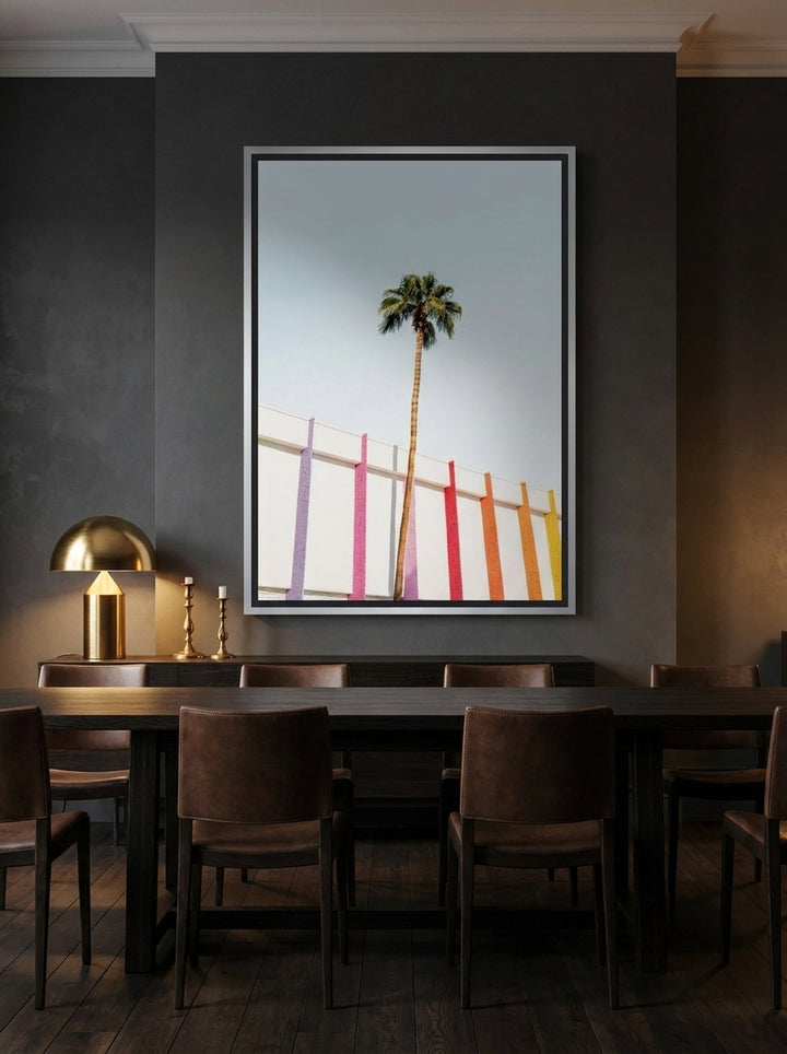 Oversized statement canvas wall art with a silver leaf surround styled on the wall in a moody dining room