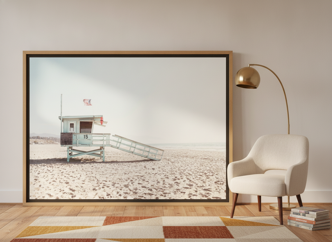 Oversized statement canvas wall art with a natural timber surround leaning against the wall in a mid-century bedroom