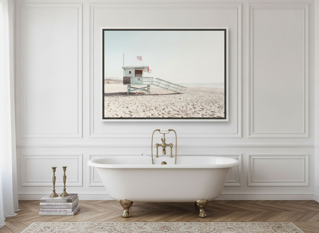 Canvas wall art with a white surround styled on the wall in a Parisian bathroom