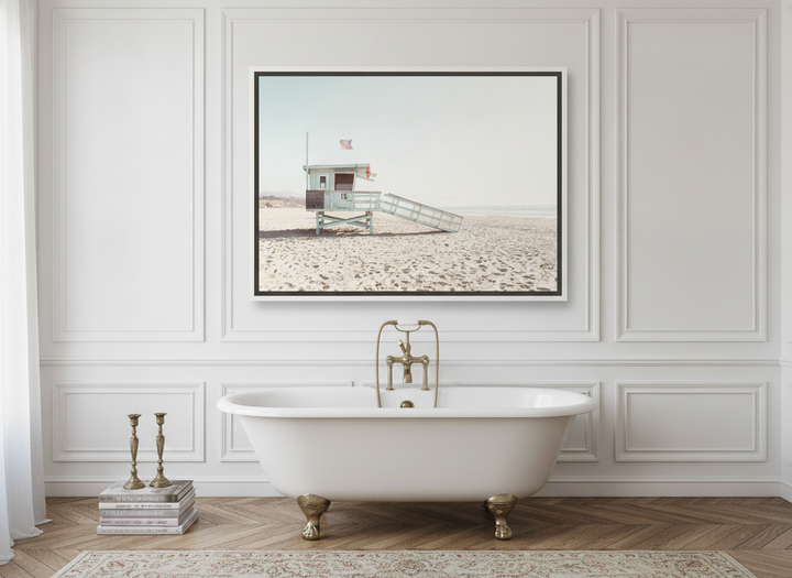 Canvas wall art with a white surround styled on the wall in a Parisian bathroom