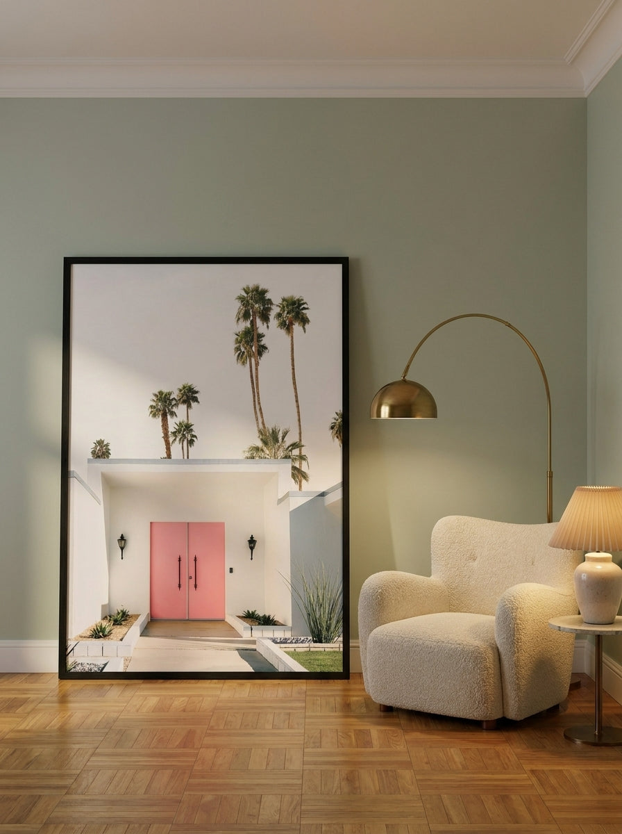 Oversized statement modern wall art print leaning against the wall in a mid-century bedroom