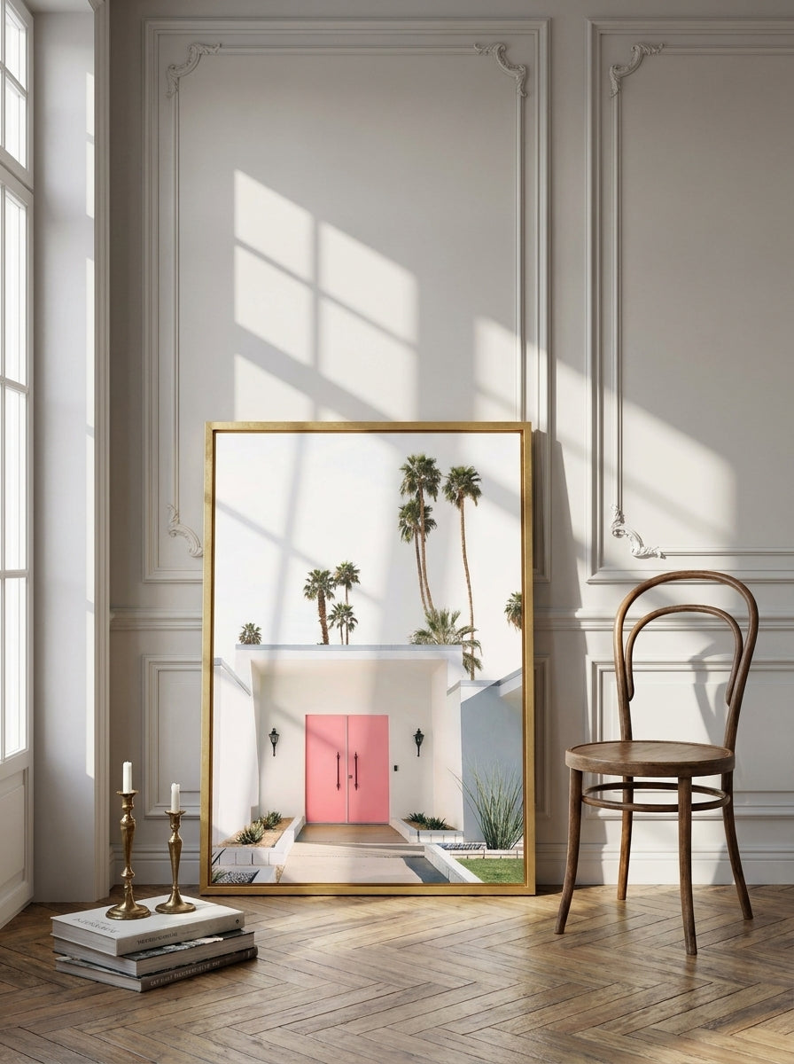 Canvas wall art with a gold leaf surround leaning against the wall in a Parisian home office