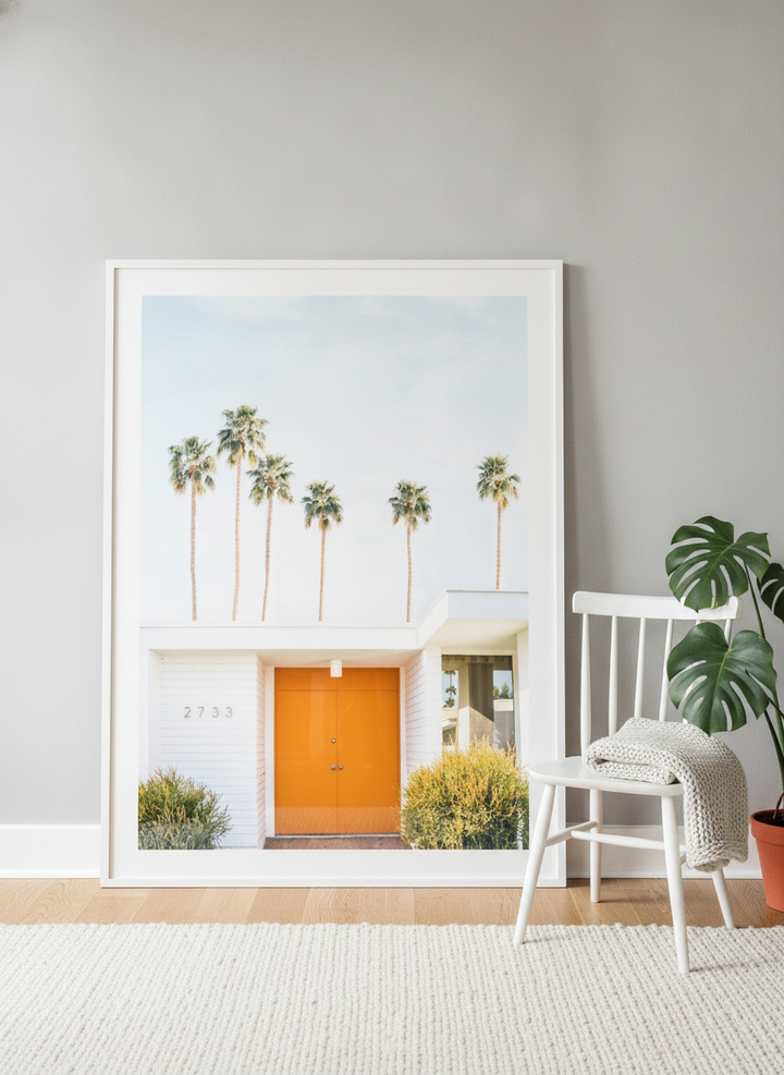 Oversized statement modern wall art print leaning against the wall in a bright Scandinavian living room