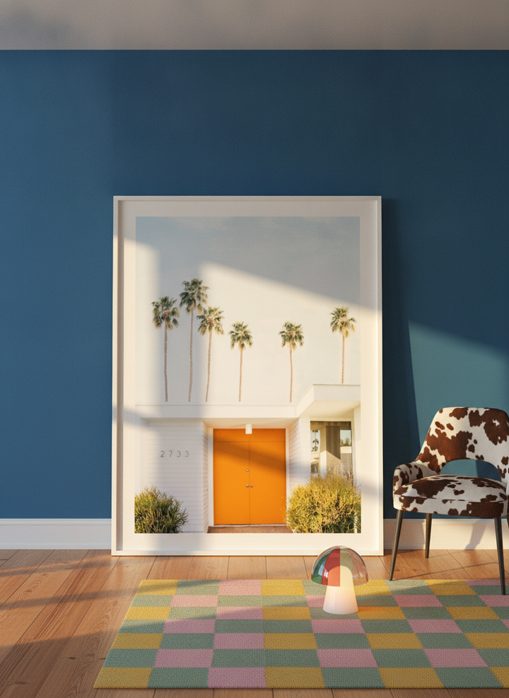 Oversized statement modern wall art print leaning against the wall in a colourful eclectic living room