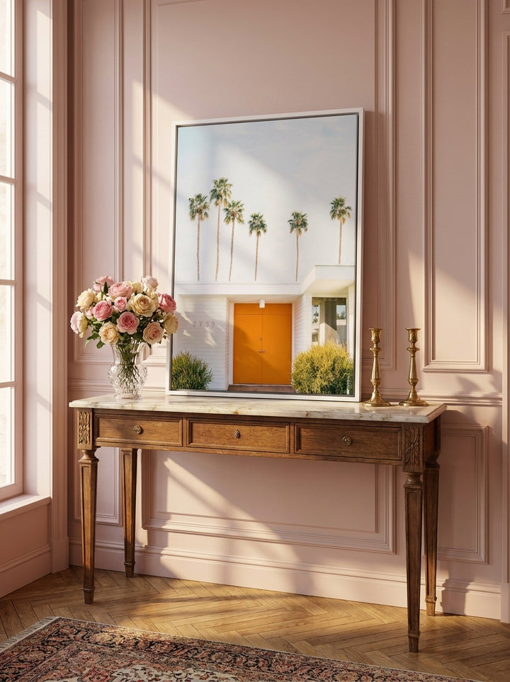 Canvas wall art with a white surround standing on a console in a Parisian bedroom