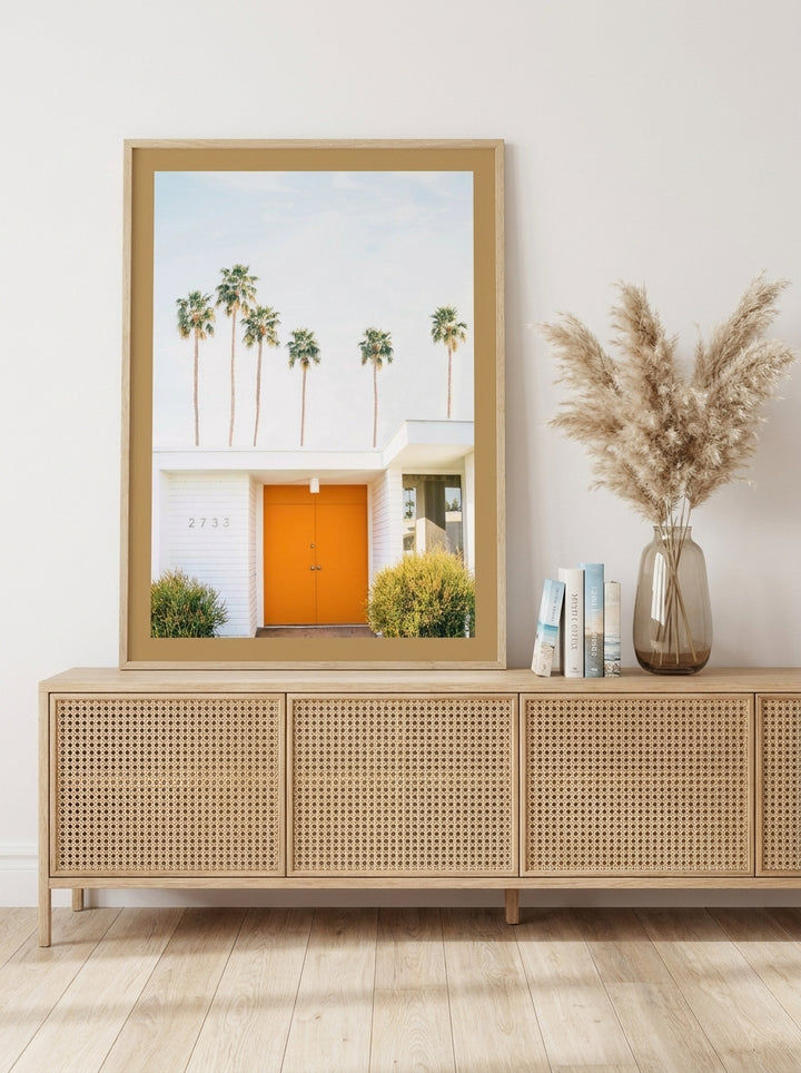 Modern wall art print standing on a sideboard in a coastal living room