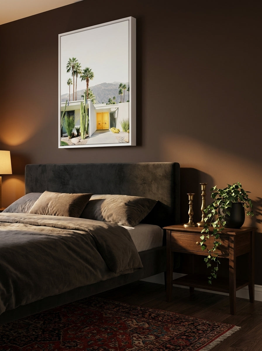 Canvas wall art with a white surround styled on the wall in a moody bedroom