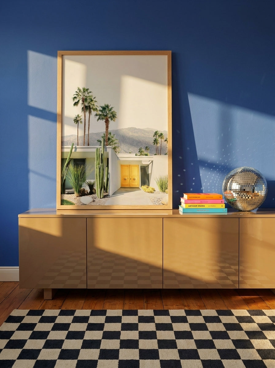 Modern wall art print standing on a sideboard in a colourful eclectic bedroom