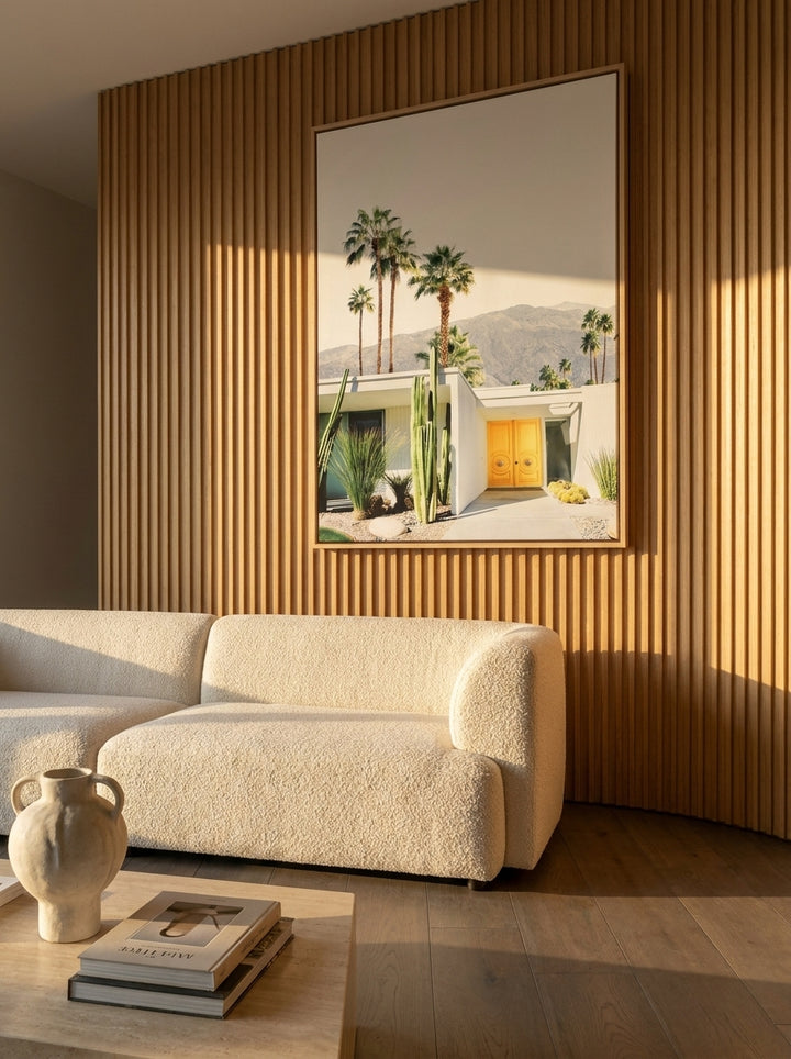 Oversized statement canvas wall art with a natural timber surround styled on the wall in a luxe living room
