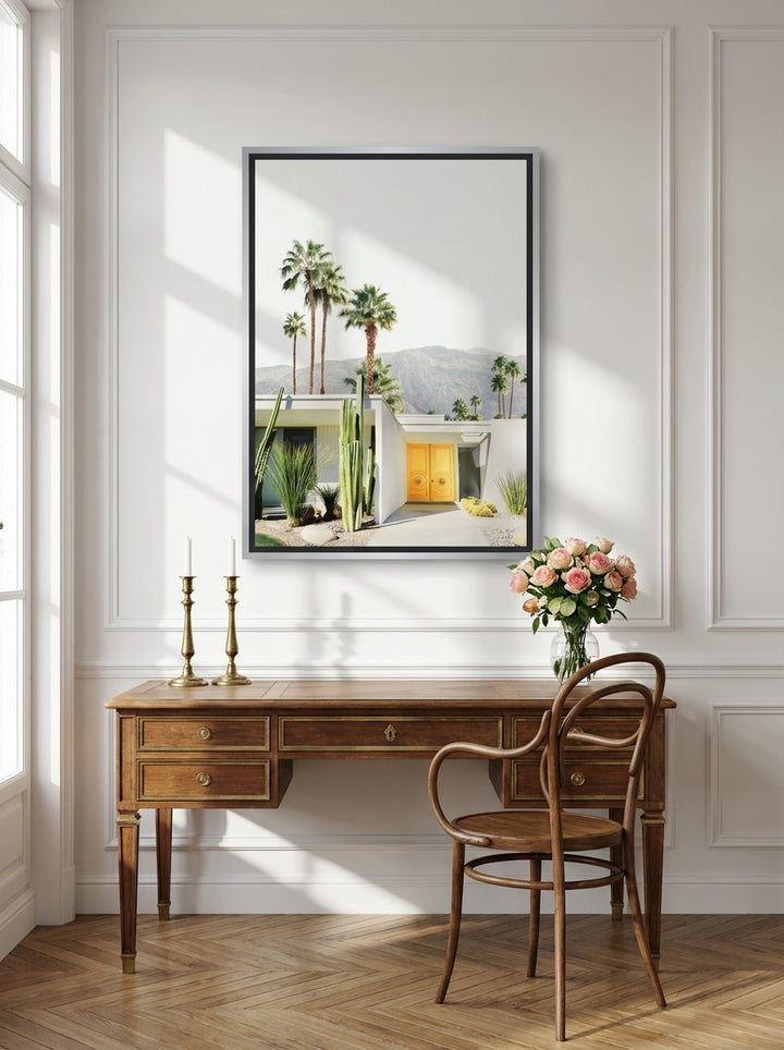 Canvas wall art with a silver leaf surround styled on the wall in a Parisian home office
