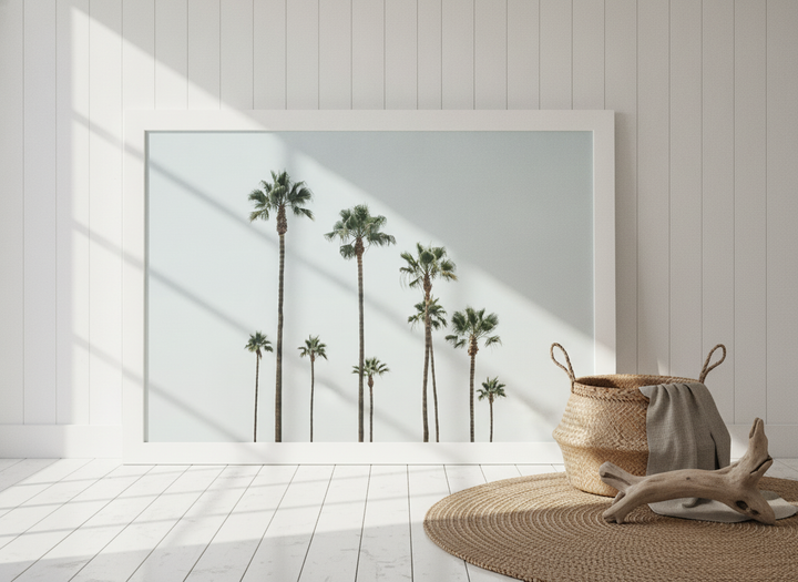 Oversized statement modern wall art print leaning against the wall in a coastal bedroom