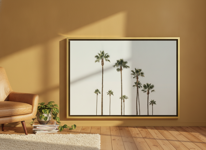 Canvas wall art with a gold leaf surround leaning against the wall in a retro 70s living room