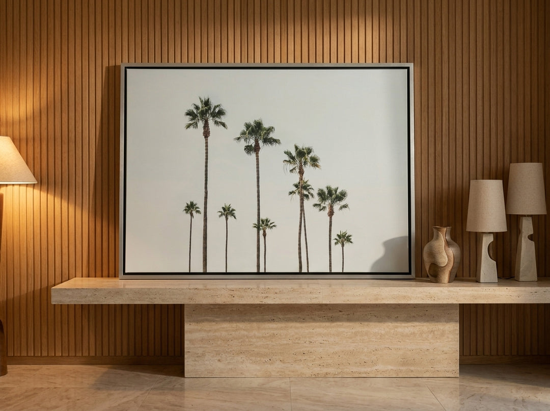 Canvas wall art with a silver leaf surround standing on a console in a luxe bedroom