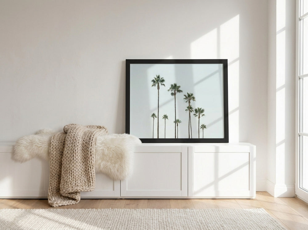 Modern wall art print standing on a sideboard in a bright Scandinavian bedroom