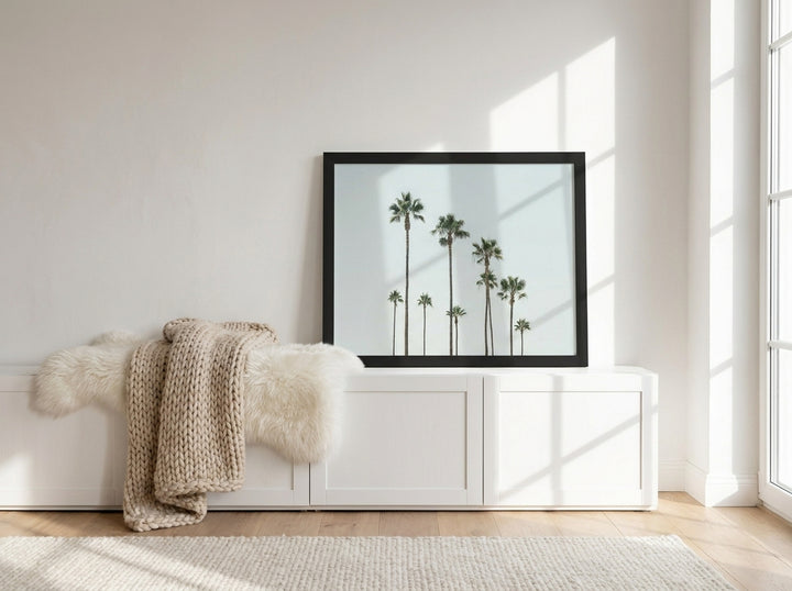 Modern wall art print standing on a sideboard in a bright Scandinavian bedroom