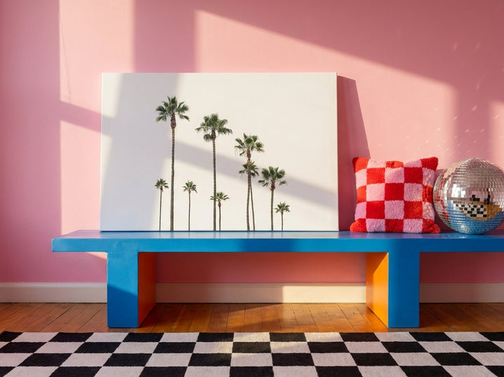 Stretched canvas wall art standing on a side table in a colourful eclectic bedroom