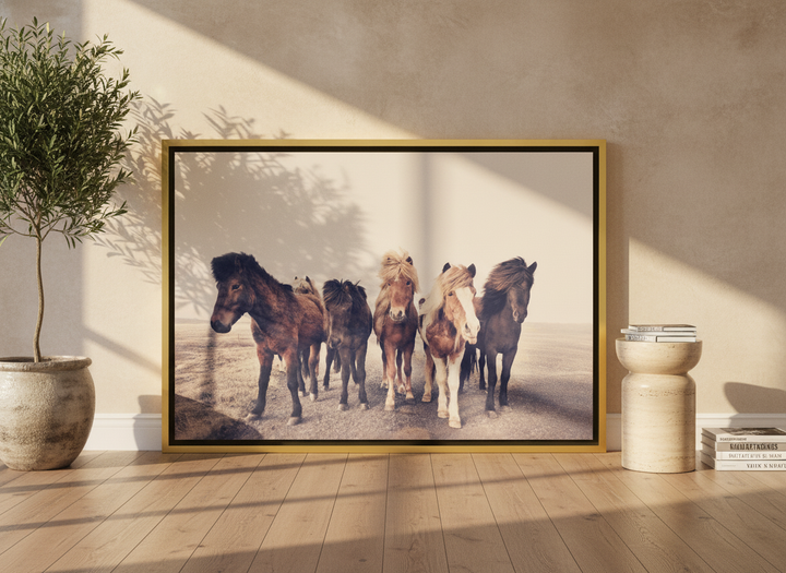 Canvas wall art with a gold leaf surround leaning against the wall in a luxe home office