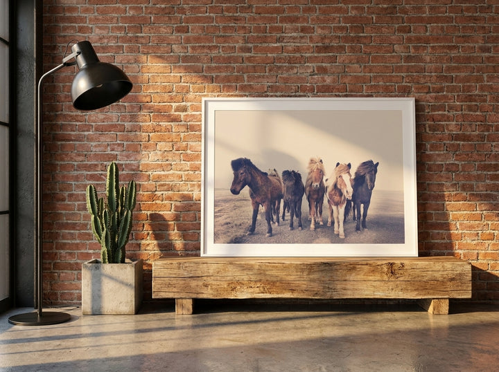 Modern wall art print standing on a bench in an industrial loft bedroom
