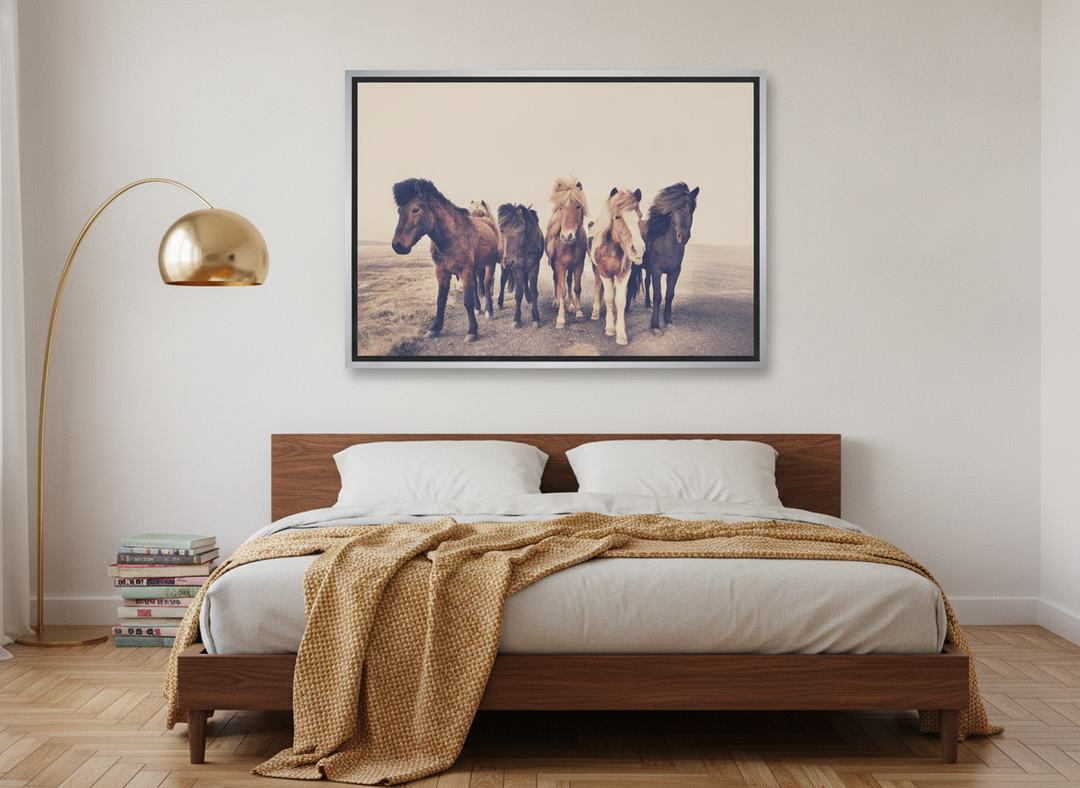 Canvas wall art with a silver leaf surround styled on the wall in a mid-century bedroom