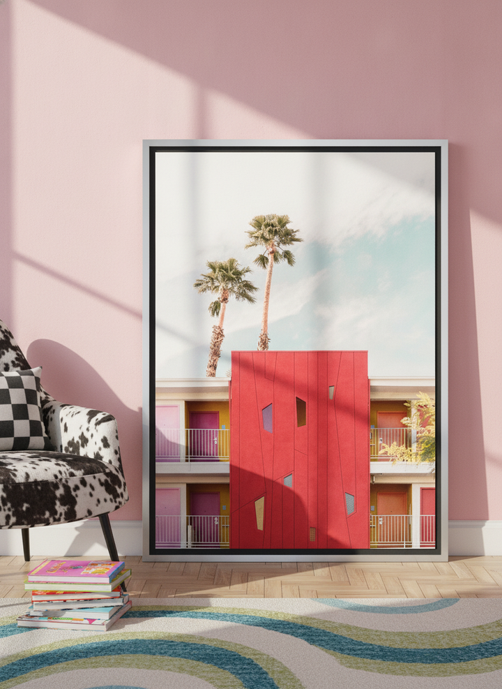 Canvas wall art with a silver leaf surround leaning against the wall in a colourful eclectic bedroom