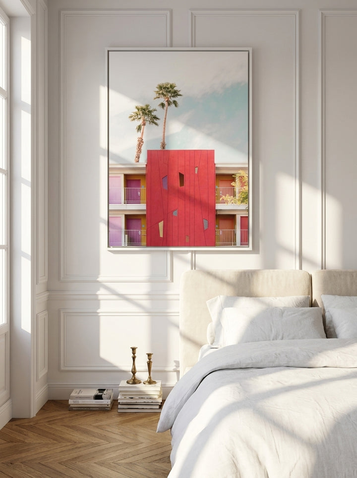 Canvas wall art with a white surround styled on the wall in a Parisian bedroom