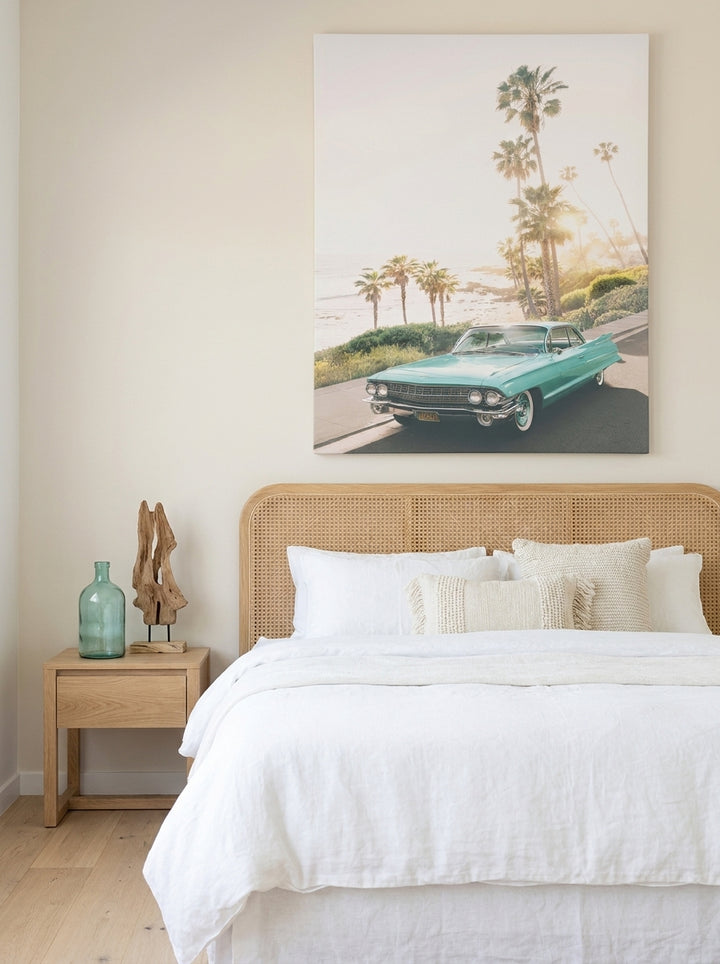 Stretched canvas wall art styled on the wall in a coastal bedroom